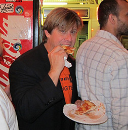 Steven Seymour in a candid shot eating New York pizza